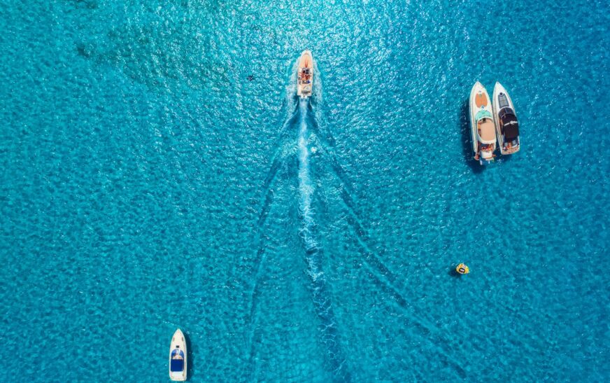 Aerial view of luxury yachts in transparent blue sea